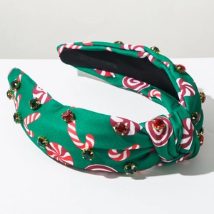 Vue détaillée du bandeau de Noël vert avec motifs de menthe et strass colorés brillants