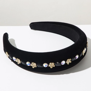 Detail of baroque black velvet headband with floral jewels and sparkling rhinestones