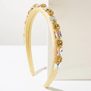 Detail of yellow padded headband featuring crystal butterflies and square rhinestones
