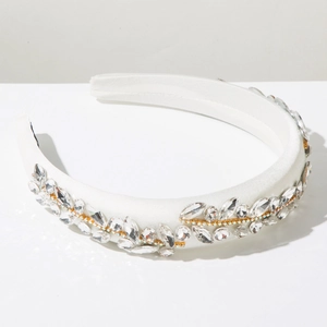 Detail of white padded headband with marquise crystals in leaf pattern over satin