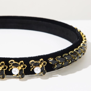 Macro shot of baroque headband with gold honeybee detail and black rhinestone gems