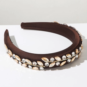 Close-up of baroque sponge headband with champagne crystals and floral gold setting
