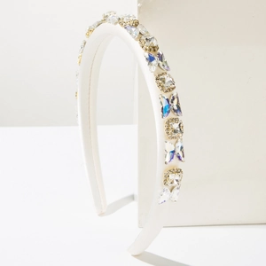 Detail of white padded headband featuring handmade butterfly crystals and square rhinestones