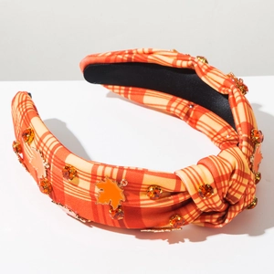 Detail of plaid headband with orange rhinestones and maple leaf ornaments for Thanksgiving