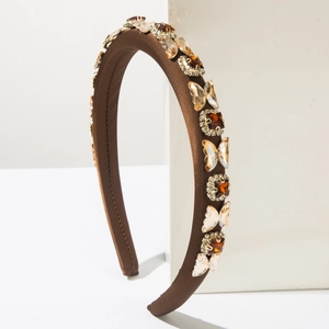 Macro detail of coffee silk headband with amber crystal butterflies and square gems
