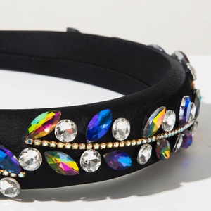 Macro detail of Baroque sponge headband with colorful rhinestones and gold chain trim