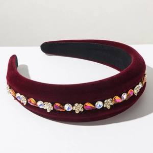 Macro shot of burgundy velvet padded headband with colorful rhinestones and floral gems