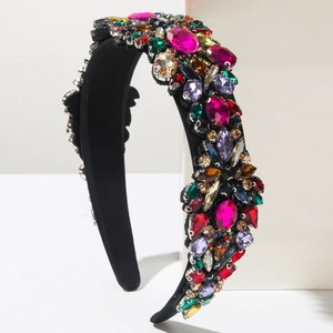Detail of vintage headband featuring multi-color rhinestones on black velvet fabric
