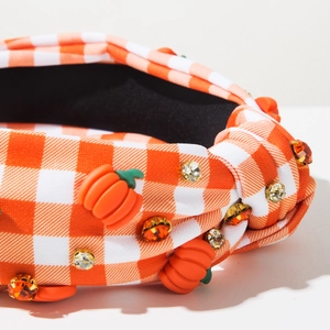 Detail of orange checkered headband with 3D pumpkins and sparkling rhinestones