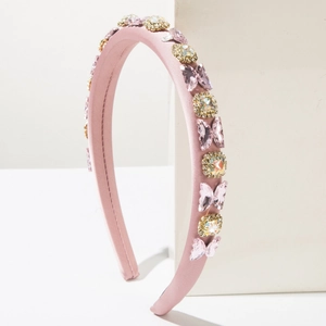 Close-up of pink satin sponge headband with crystal butterflies and sparkling rhinestones