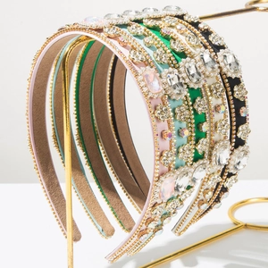 Close-up of luxury Baroque headband set with large rhinestones and gold chain details