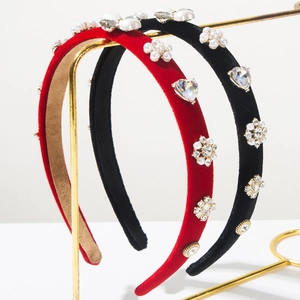 Close-up of velvet headband featuring baroque pearls, crystal hearts and gemstones