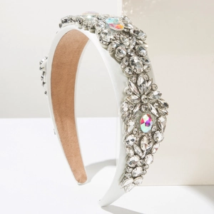 Close-up of white satin luxury headband with sparkling crystals and colorful AB stones