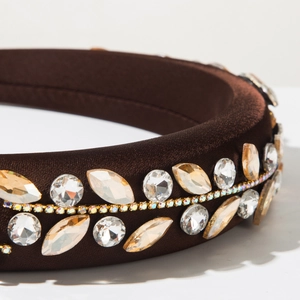 Detailed close-up of brown padded headband featuring dual-row crystals and gold chain
