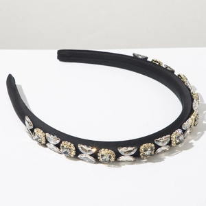 Macro shot of black satin headband with gold-set crystal rhinestones and diamonds