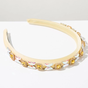 Detail of yellow satin headband featuring square crystals and colorful butterfly wing decor