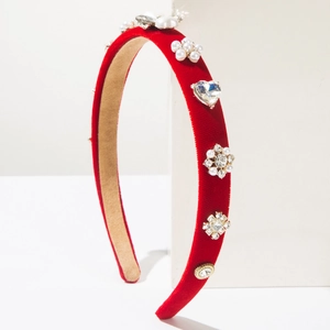 Detailed macro view of luxury red velvet headband with pearls and heart rhinestones