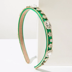 Detail of baroque rhinestone headband with emerald green satin and gold settings