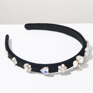 Close-up of black velvet headband with elegant pearls and sparkling heart rhinestones