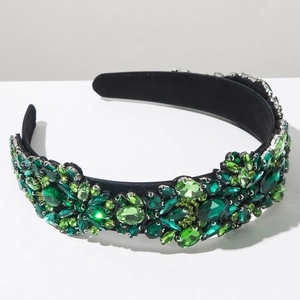 Detail of luxury padded headband featuring hand-set green crystals and emerald gems