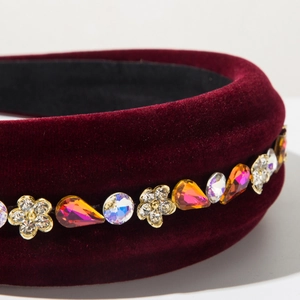Detail of burgundy velvet headband with sparkling floral rhinestones and crystal accents
