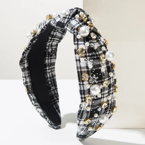 Detail of Christmas headband with checkered fabric, faux pearls, and snowflake patterns