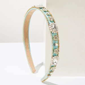 Close-up of light blue satin headband with intricate rhinestone and pearl flower details