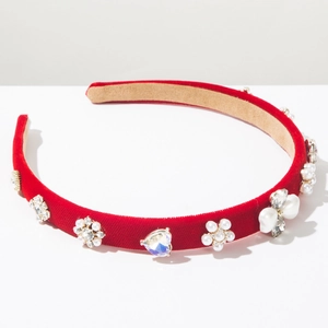 Detail of red velvet headband with luxurious pearls and crystal heart embellishments