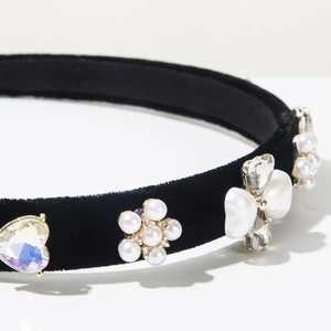 Detail of baroque headband with pearls, heart-shaped rhinestone, and black velvet fabric