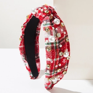 Detail of red plaid Christmas headband with white snowflakes, pearls and crystals