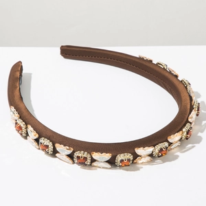 Close-up of brown satin headband featuring luxury amber rhinestones and elegant vintage texture