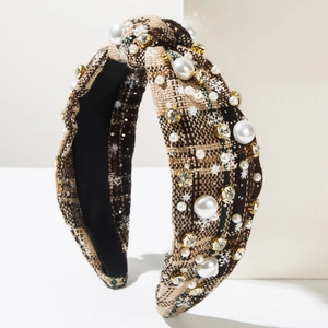 Detail of tartan knotted headband with pearl accents, rhinestones and snowflake patterns
