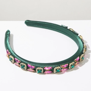 Detail view of dark green satin headband featuring sparkling pink and green rhinestones