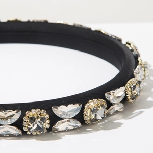 Close-up of black padded headband with sparkling crystals and butterfly accents