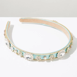 Close-up of light blue crystal headband with intricate rhinestone flower details