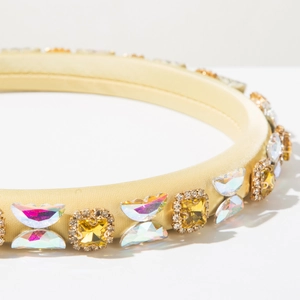 Detailed close-up of champagne satin headband featuring sparkling crystals and rhinestones