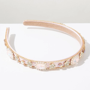 Detailed close-up of pink baroque headband with crystals and rhinestone flowers