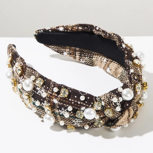 Close-up of knotted brown tweed headband with sewn faux pearls and sparkling rhinestones