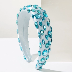Detail of aqua blue crystal gemstones hand-sewn on a luxury satin padded headband
