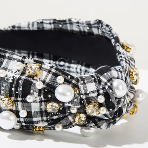 Detailed view of the plaid headband fabric with inlaid pearls and sparkling rhinestones