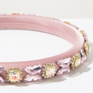 Close-up of pink satin sponge headband with rhinestone butterflies and crystal detail