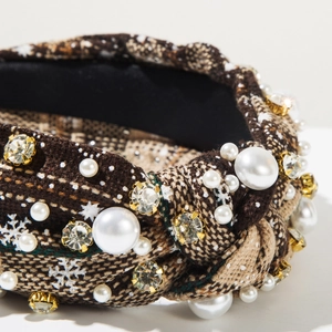 Detailed close-up of tweed Christmas headband with white snowflakes, pearls and crystals