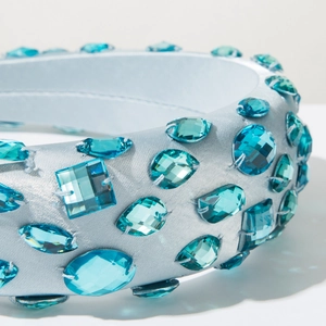 Close-up of luxury sky blue padded headband with hand-sewn geometric crystal embellishments
