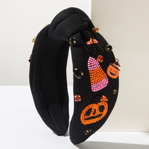 Close-up of Halloween knot headband with pumpkin beadwork and crystal rhinestones