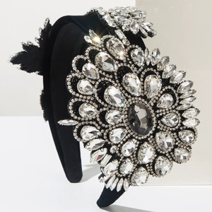 Macro view of crystal flower detail on luxurious black velvet baroque headband