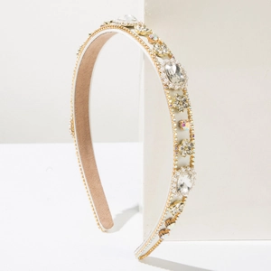 Baroque padded headband with sparkling crystals and pearls on elegant stone display
