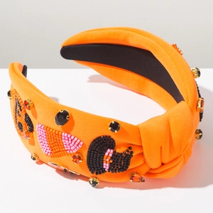 Close-up of orange knotted headband featuring handmade beadwork and rhinestones