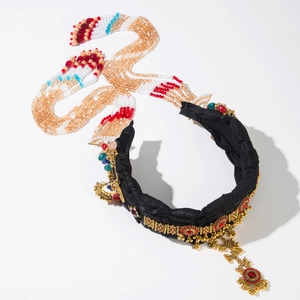 Ethnic style headband with hanging beads and gemstones on a black pleated band