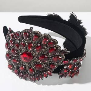 Detailed close-up of Baroque velvet headband with heavy red rhinestone floral patterns