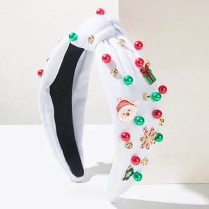 Dettaglio fascia natalizia bianca con ciondoli di Babbo Natale, fiocchi e strass
